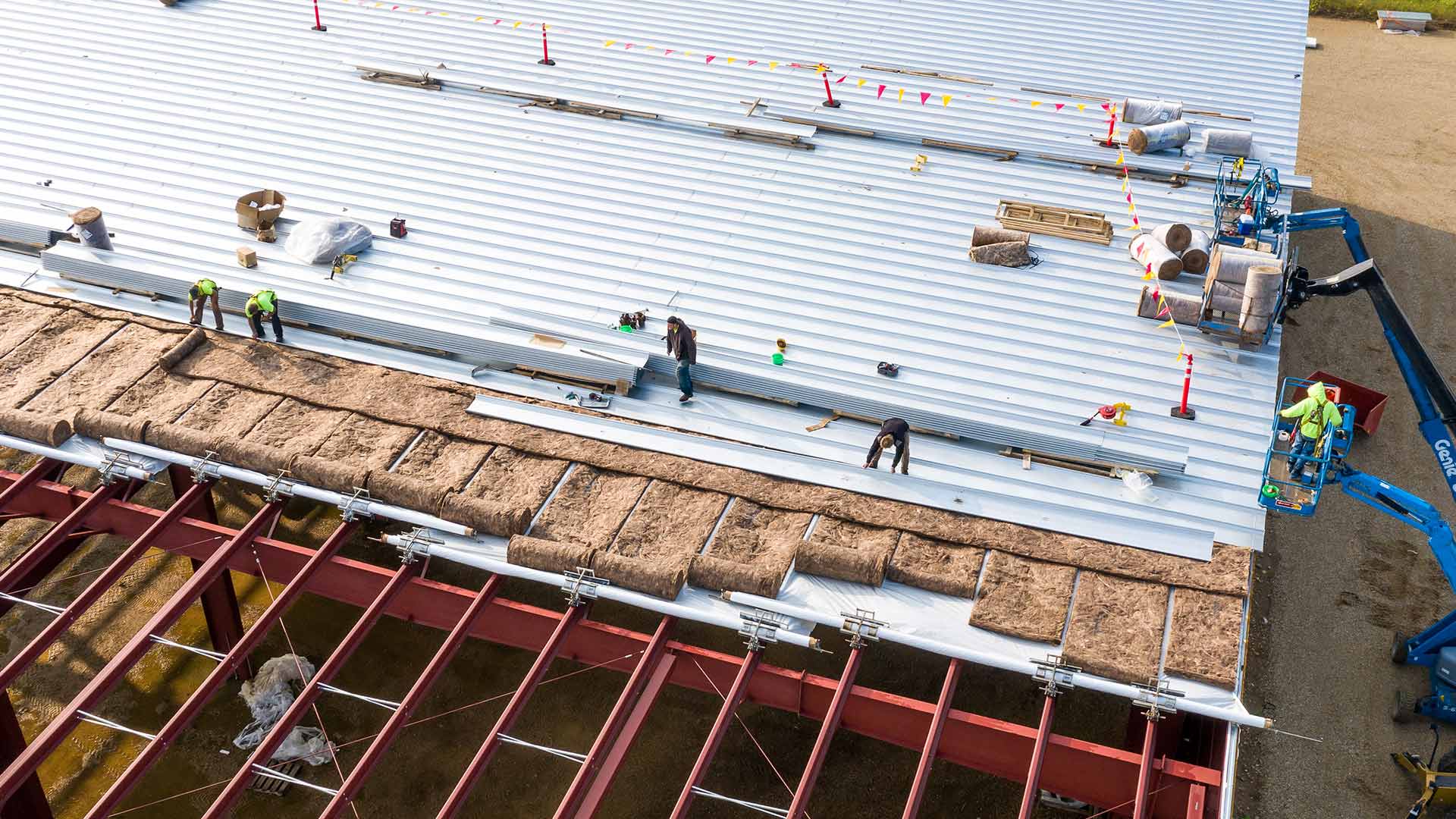 aerial-view-of-group-of-contractors-installing-metal-roof-at-commercial-building-longview-tx