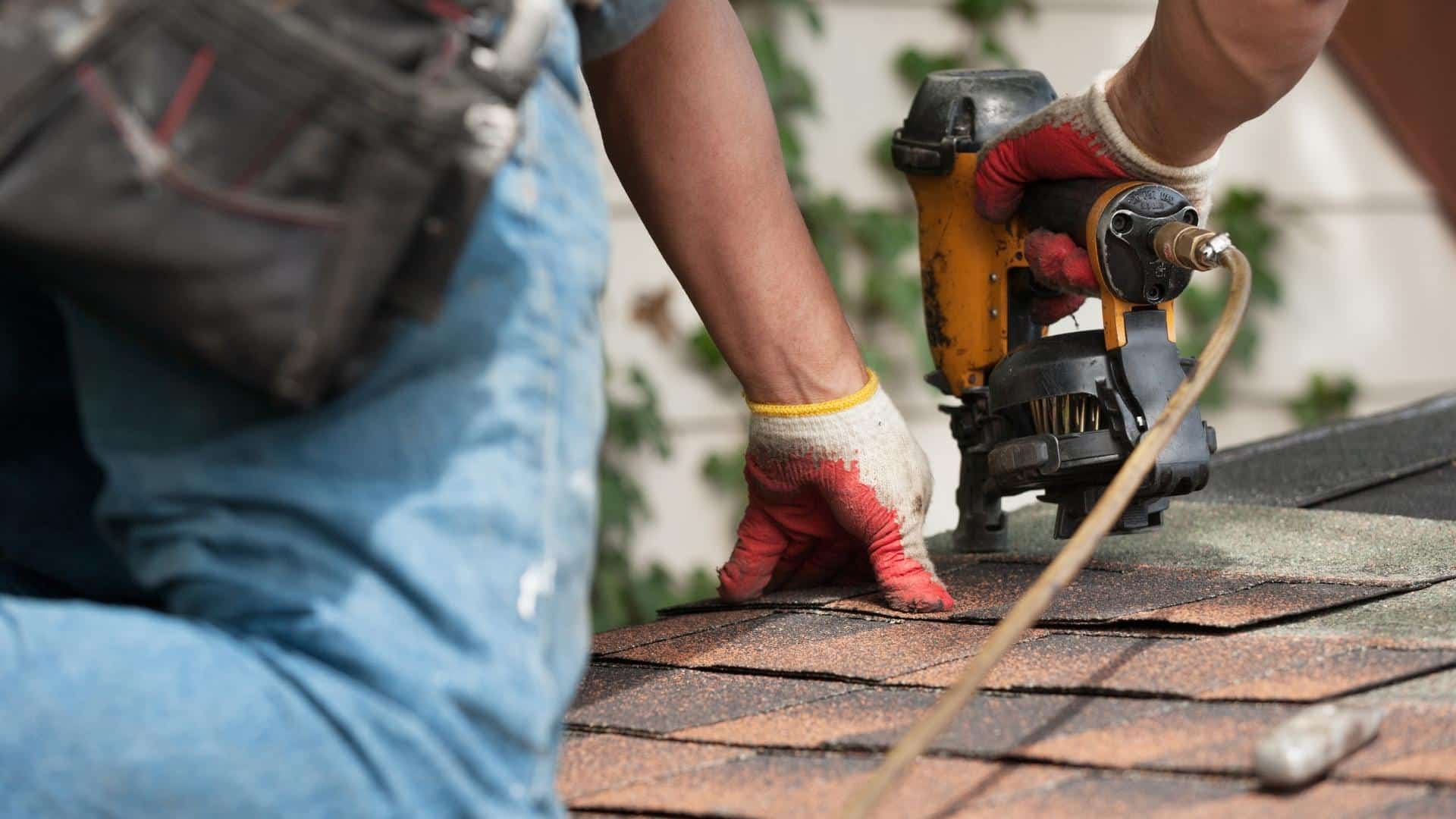 roofer-close-up-with-nailgun-installing-asphalt-shingles-roof-at-house-marshall-tx